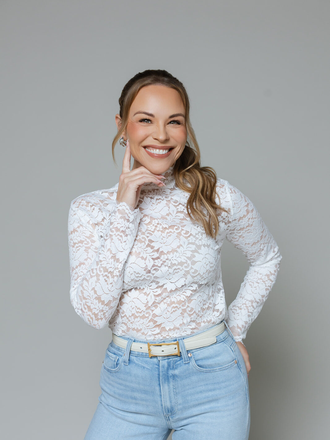 Julie Solomon in a white lace top, smiling