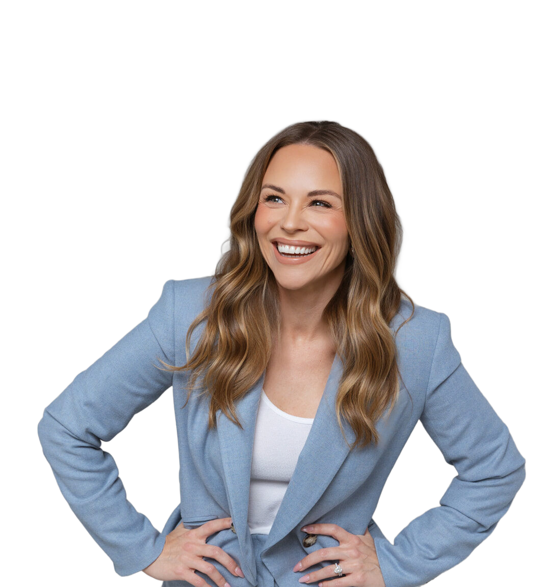 Julie Solomon in a blue suit, smiling with hands on hips